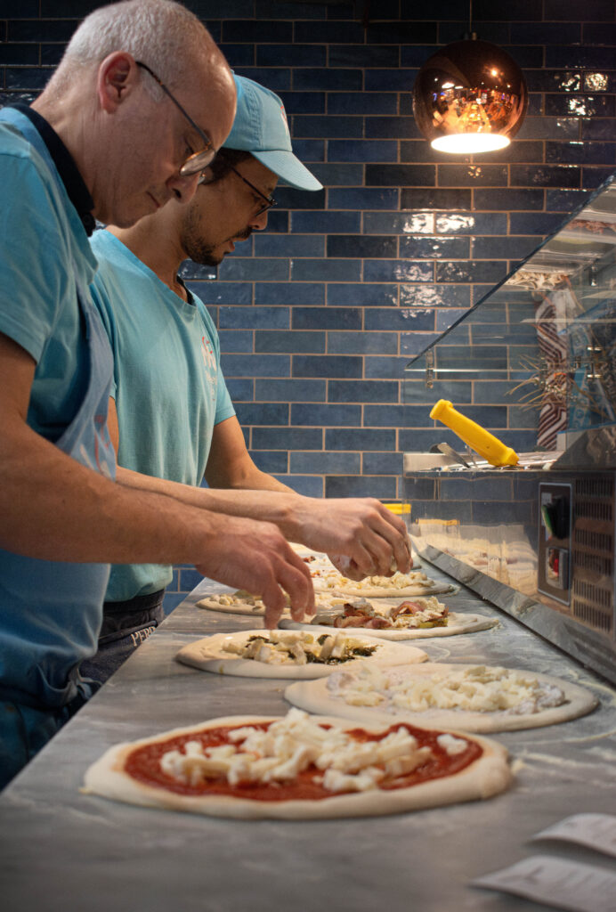 Neapolitan pizza with fresh basil, mozzarella, and tomato sauce on a wooden board