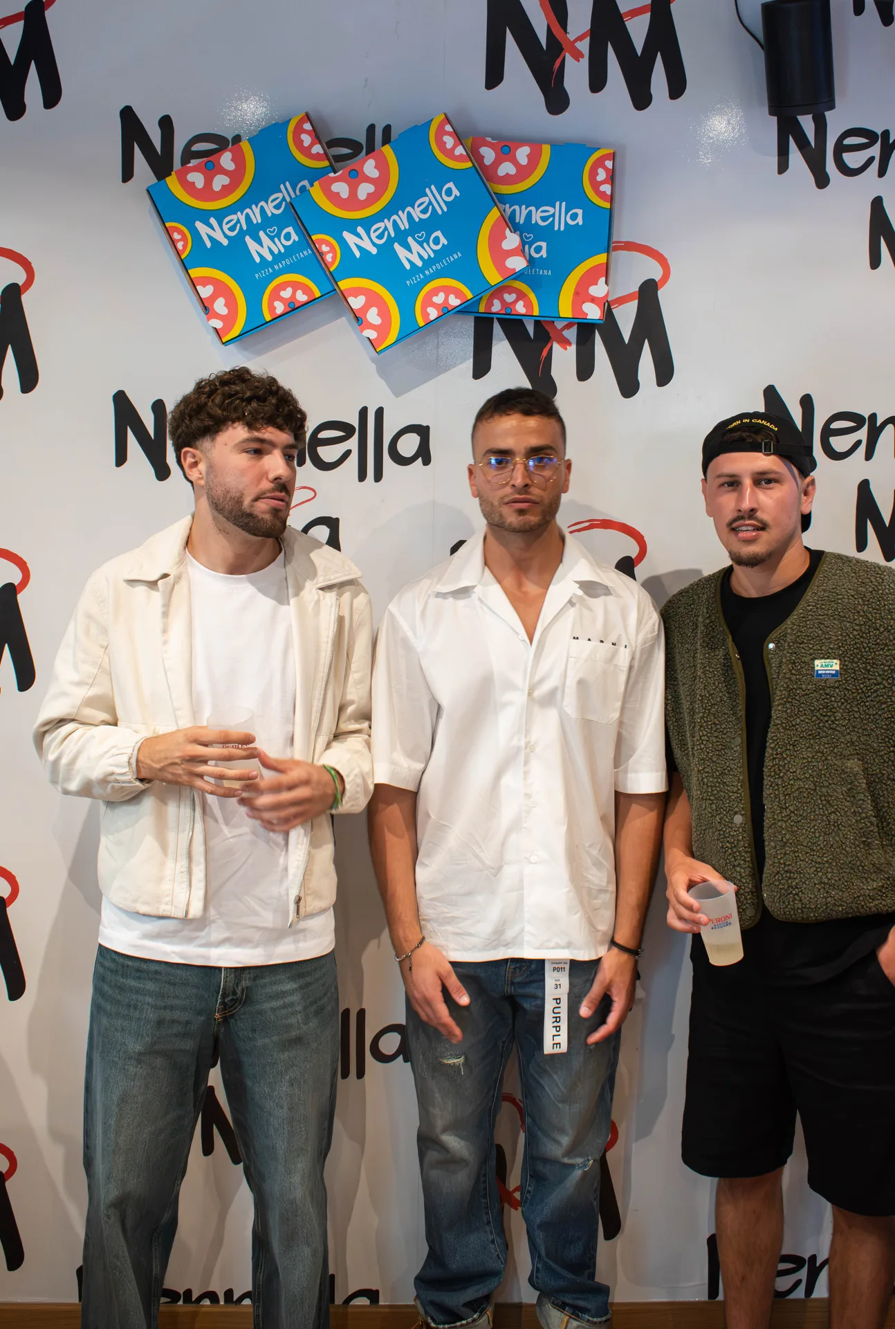 Pizzaiolo façonnant une pizza devant un four à bois dans une salle chaleureuse